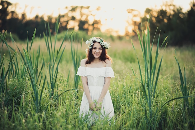 Happy attractive girl in white dress smiling happily