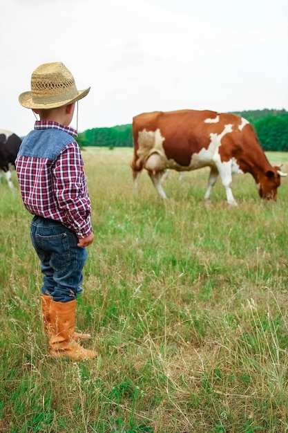 Happy baby cowboy in nature