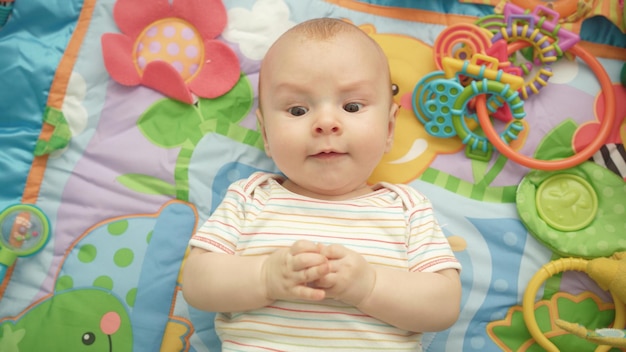 Happy baby emotion Portrait of cute child lying back Sweet kid enjoy world