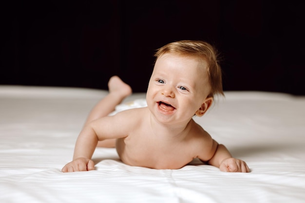 Happy baby portrait on bed child in bed