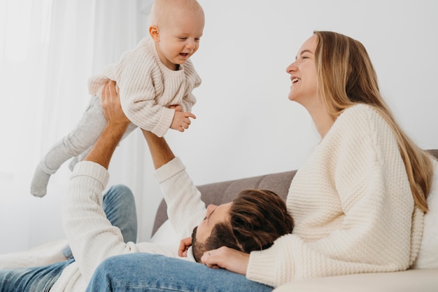 Happy baby with mother and father at home