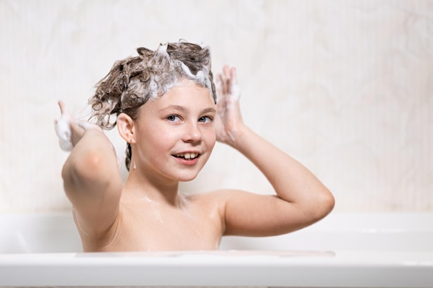 Happy bathing baby with foam on his head