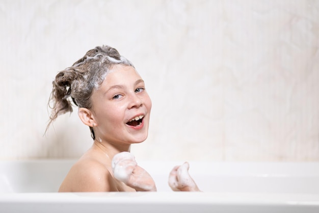 Happy bathing baby with foam on his head