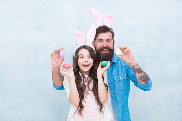 Happy to be a family Daughter and father hunting eggs for Easter holiday Having fun on Easter father and daughter bunny family fun happy family time wearing rabbit ears for spring holiday