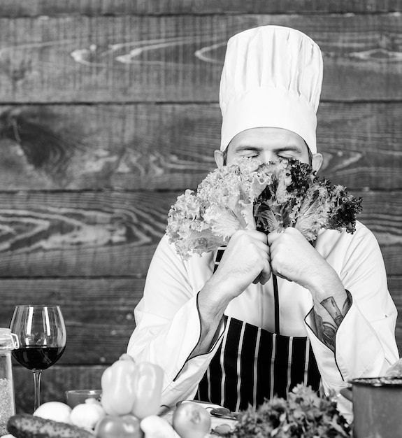 Happy bearded man chef recipe Dieting organic food Cuisine culinary Vitamin Healthy food cooking man with beard Vegetarian salad with fresh vegetables Only the best fruits and vegetables