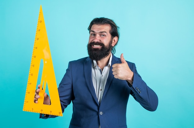 Happy bearded man hold math tool triangle ruler calculation and search of various data