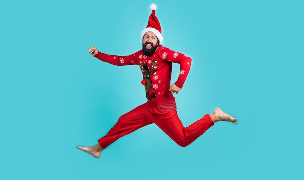 Happy bearded man in red santa claus costume running and feel happiness about christmas shopping sales, new year celebration.