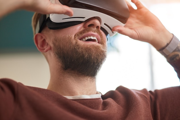 Happy bearded man in virtual reality headset