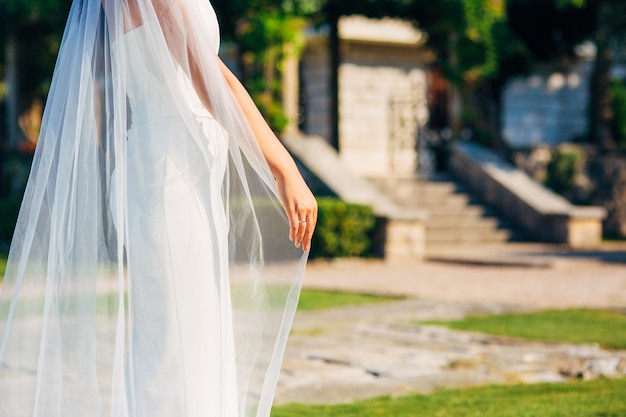 Happy beautiful bride outdoors wedding dress fluttering