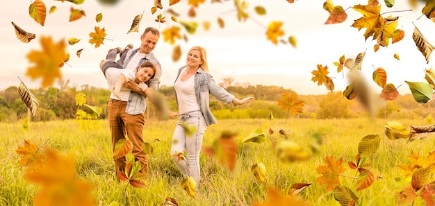 happy beautiful family of five on a walk in the autumn against the background of yellow leaves.