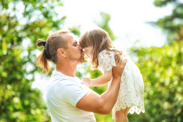 Happy beautiful family together father and daughter portrait on a walk on a Sunny summer day