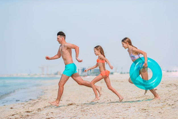 Happy beautiful family on a tropical beach vacation