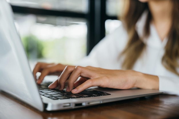 Happy beautiful freelancer typing keyboard on laptop working online work outside office