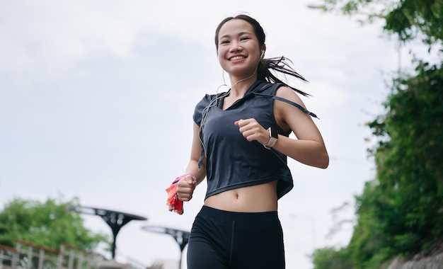 Happy beautiful girl exercise jogging with blue sky background