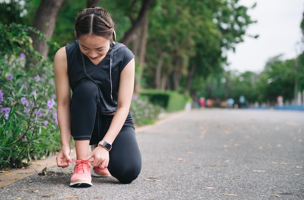 Happy beautiful girl exercise jogging with tree background