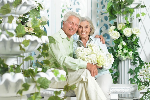 Happy beautiful senior couple posing at home