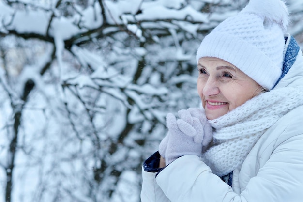 Happy beautiful senior woman in warm hat