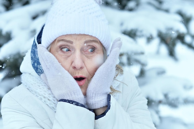 Happy beautiful senior woman in warm hat