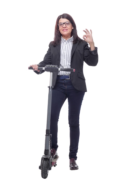 Happy beautiful woman standing near kick scooter