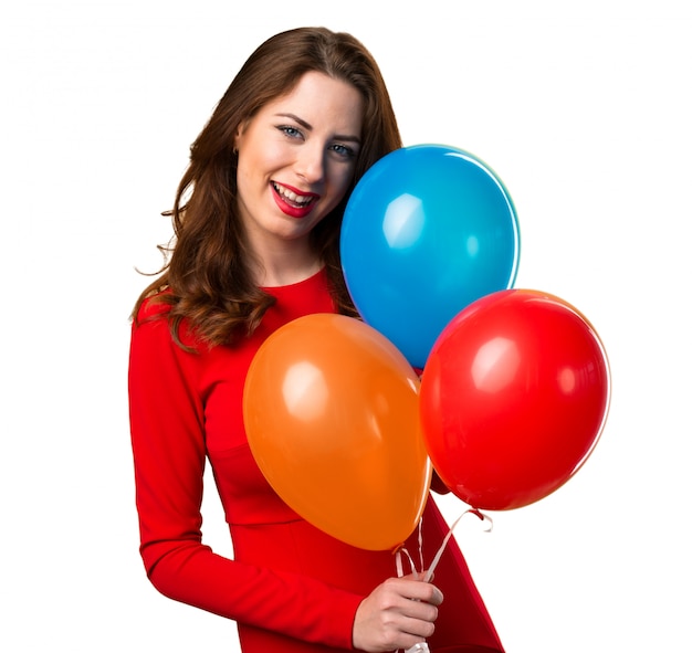 Happy beautiful young girl holding balloons