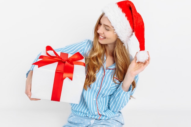 Happy beautiful young woman in Christmas pajamas