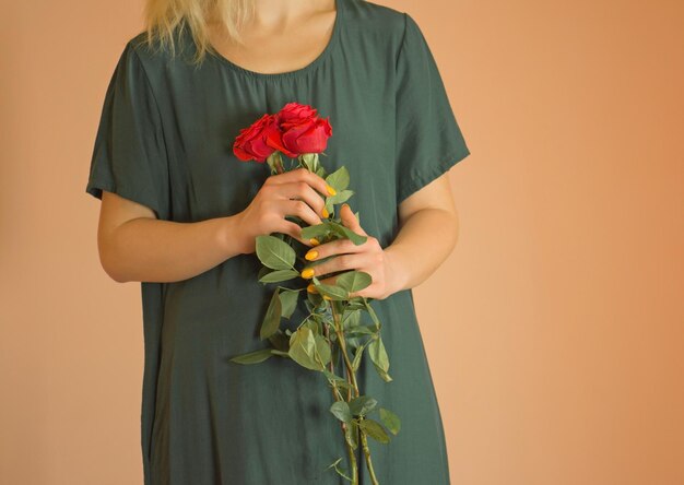 Happy beautiful young woman with flowers Young smiling blonde girl enjoying a bouquet of flowers