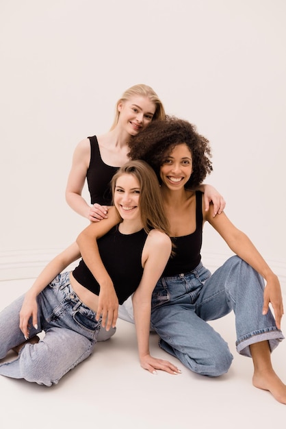 Happy beauty portrait young women of different nationality in casual clothes on white background