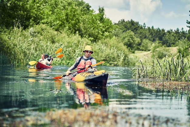 Happy best friends having fun on a kayaks. Kayaking on the river.