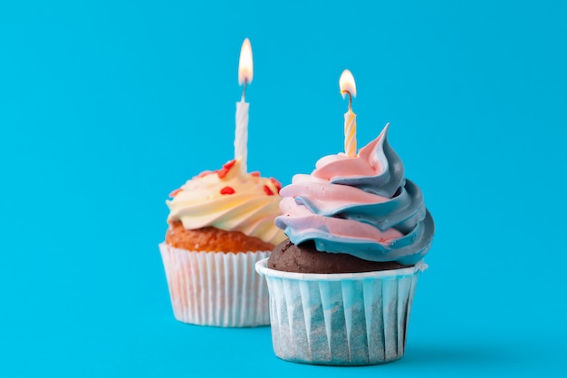 Happy birthday cupcakes on bright colored wall