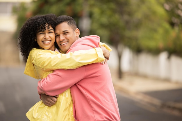 Happy black couple hug and love portrait of people with care and bonding outdoor Young woman man and summer fun on a street walking with happiness embrace on vacation smiling together