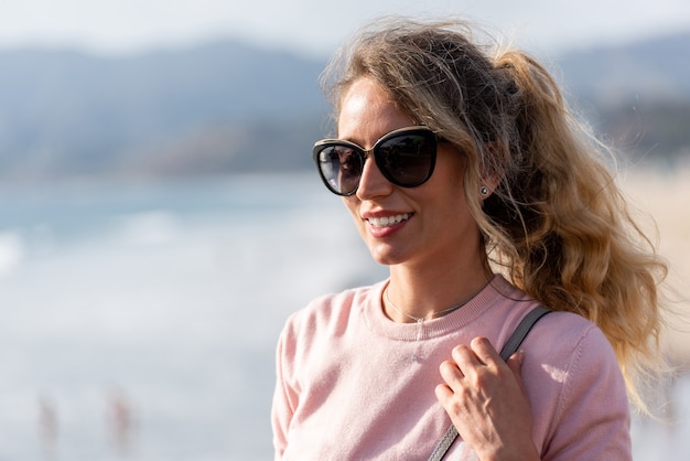 Happy blonde woman at the beach of Los Angeles