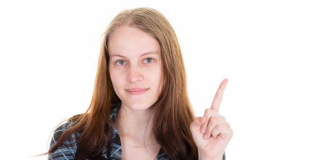 Happy blonde young cheerful woman points forefinger showing presenting blank empty copy space isolated on white background