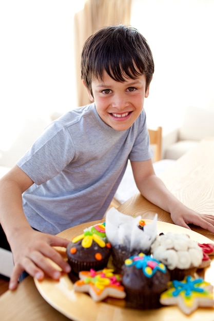 Happy boy eating colorful confectionery