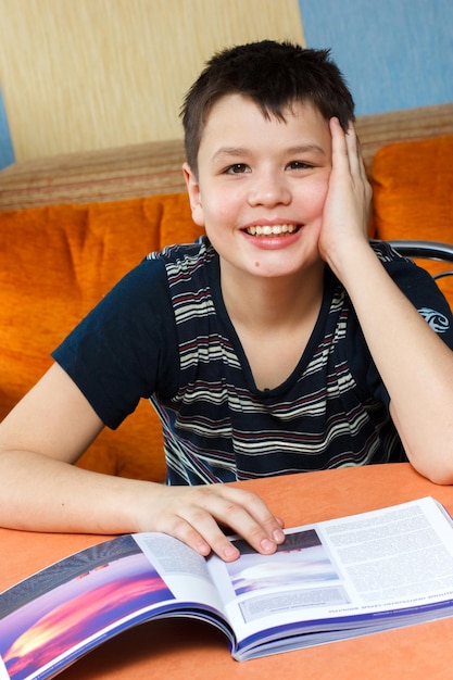 Happy boy reading a book