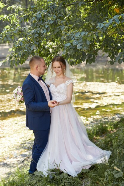 Happy bride and groom hugging and kissing, love