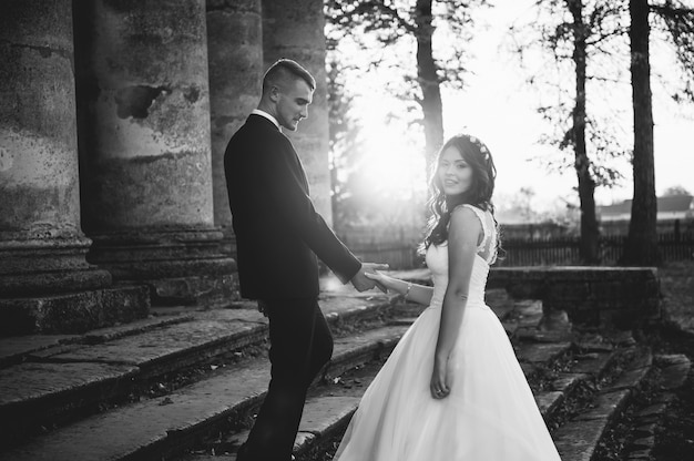 happy bride and groom near the medieval palace on their wedding day