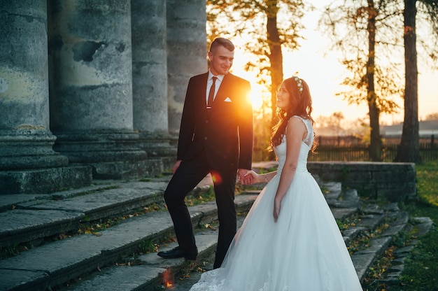 happy bride and groom near the medieval palace on their wedding day