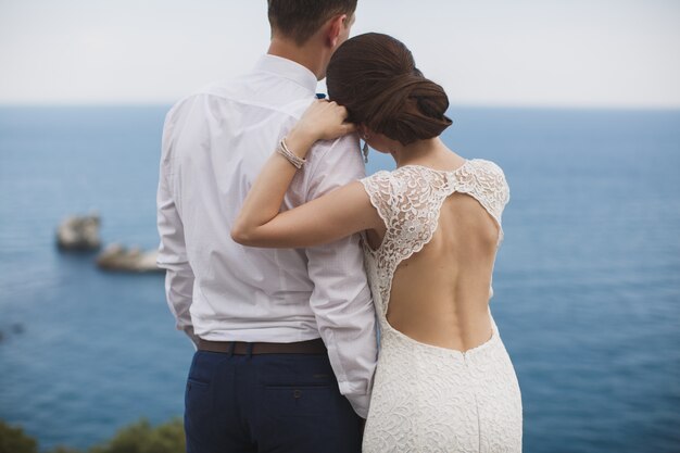 Happy bride and groom on their wedding hugging