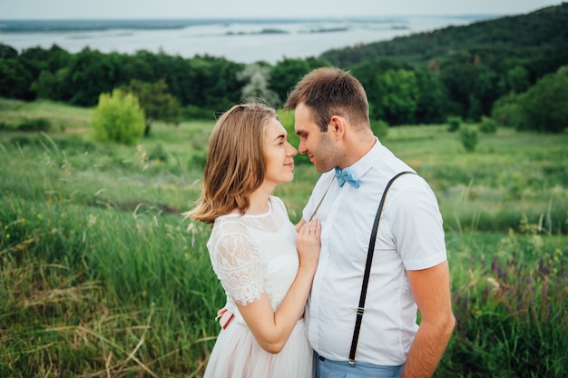 Happy Bride and groom walking on the green grass