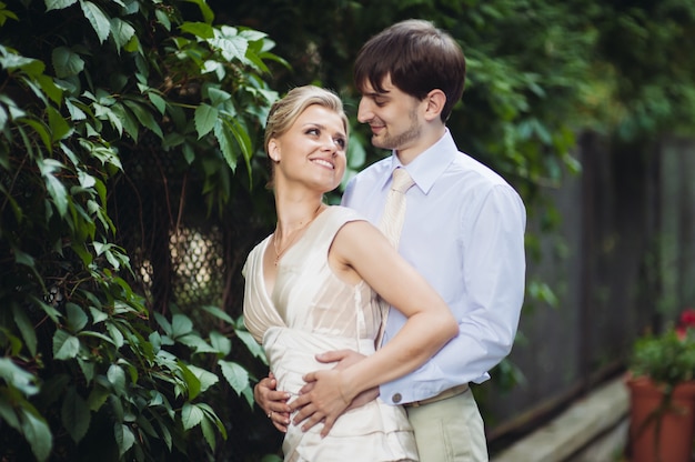 Happy bride and groom walking in the park on their wedding day