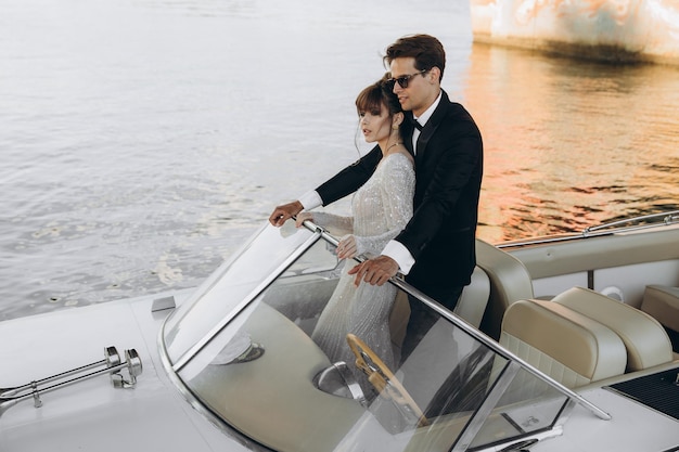 Happy bride and groom on a yacht traveling together on a warm summer day