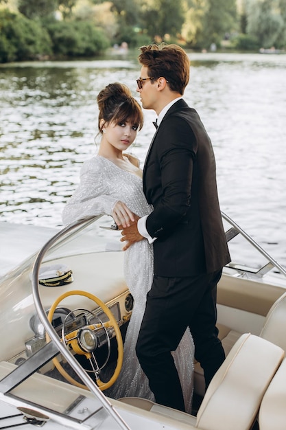 Happy bride and groom on a yacht traveling together on a warm summer day