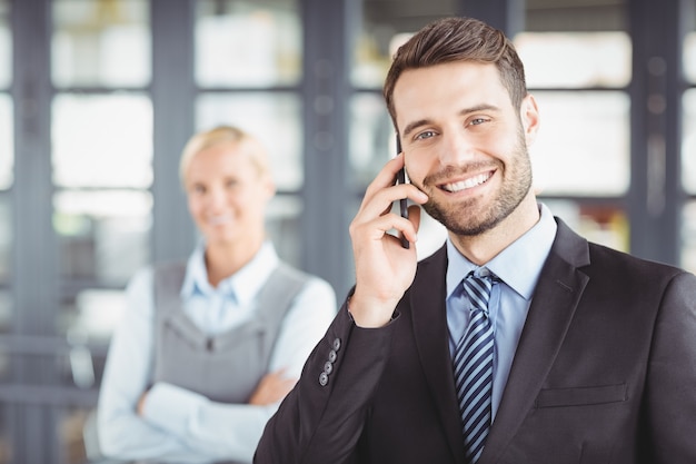 Happy businesman talking on mobile phone