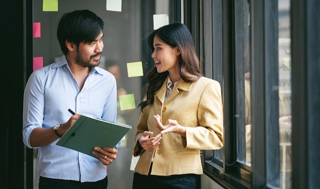 Happy business colleagues having discussion during working at office