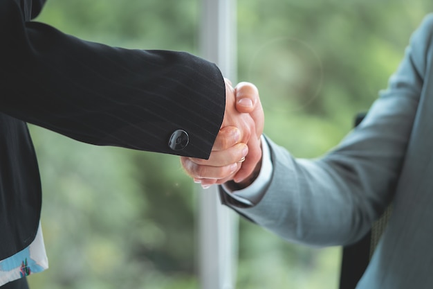 Happy business man with confidence handshake with partner