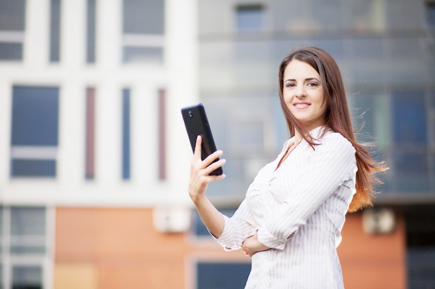 Happy business woman using a tablet computer 