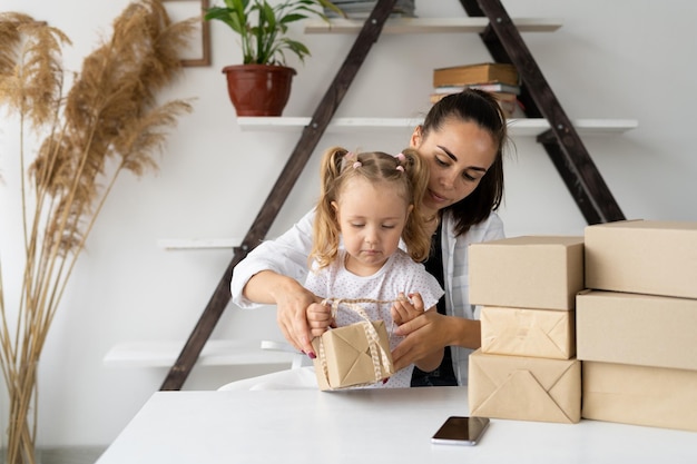 Happy business woman working at home office packing a box of goods to be shipped