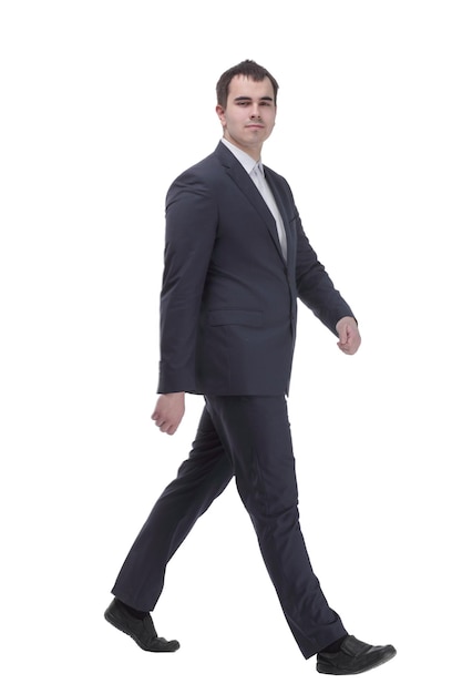 Happy businessman in black suit walking in front of the camera