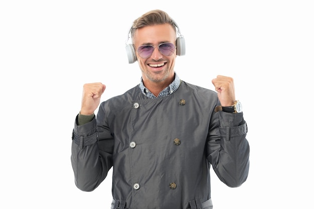 Happy businessman celebrating with music making winning gesture music