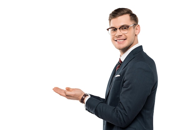 Happy businessman in glasses gesturing and smiling isolated on white